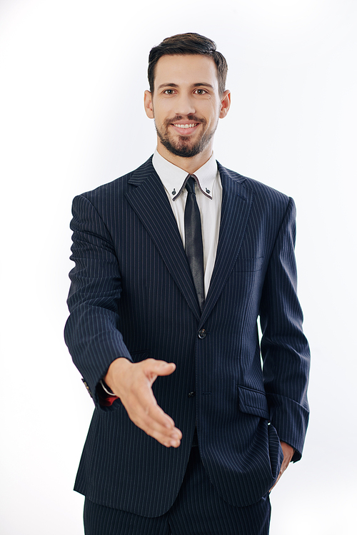 Portrait of smiling confident young entrepreneur outstretching hand for handshake