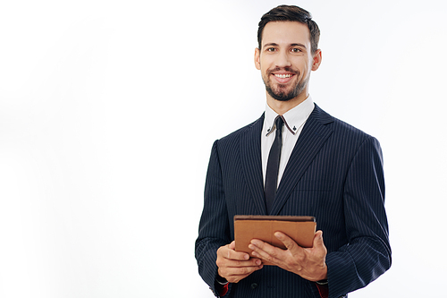 Portrait of smiling confident young businessman with digital tablet looking at camera