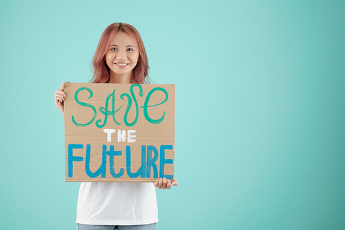 Pretty young Asian woman holding save the future sign when she made for protest