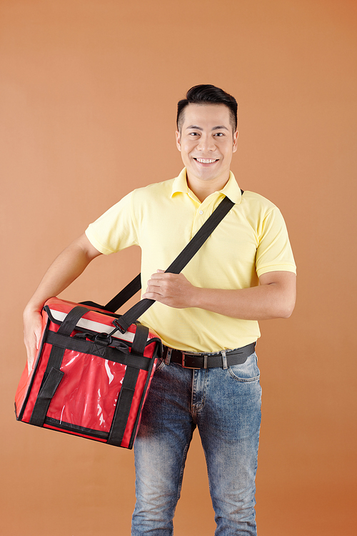 Smiling delivery man with big insulated thermo bag with fresh food