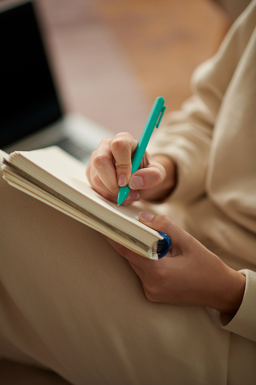 Closeup image of woman writing in gratitude journal or planner