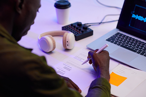 Blogger checking scenario when editing podcast in his studio