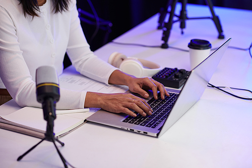 Hands of blogger answering comments of subscribers after uploading new video