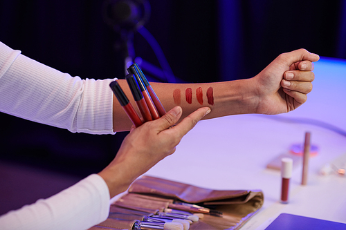 Beauty blogger showing swatches of liquid lipsticks from new collection