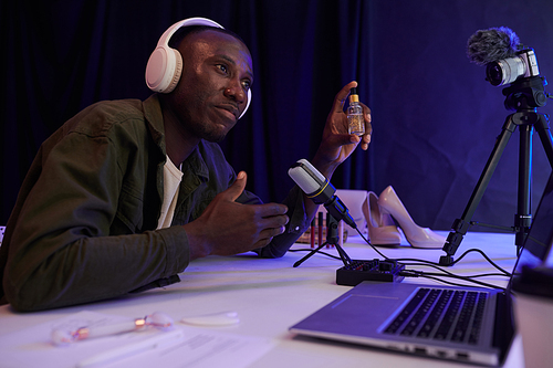 Black man recording his opinion on female beauty products, cosmetics and shoes