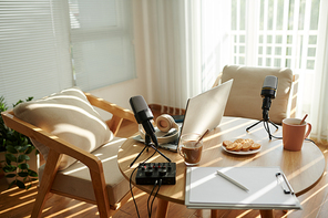 Professional microphone on desk of podcaster, selective focus