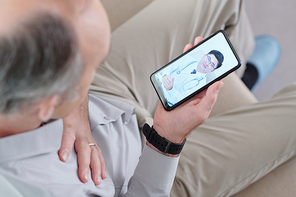 Mature man video calling his doctor to discuss disease symptoms, diagnosis and treatment