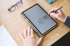 Hands of graphic designer sketching ideas on tablet computer