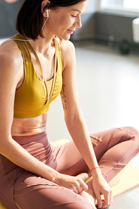 Side view portrait of contemporary young woman  listening to music while enjoying yoga in sunlight