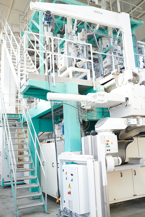 Interior of production workshop at modern factory, group of modern machines in white and blue , copy space