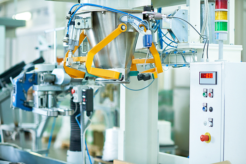 Interior of production workshop at food factory, modern machine units in focus, copy space