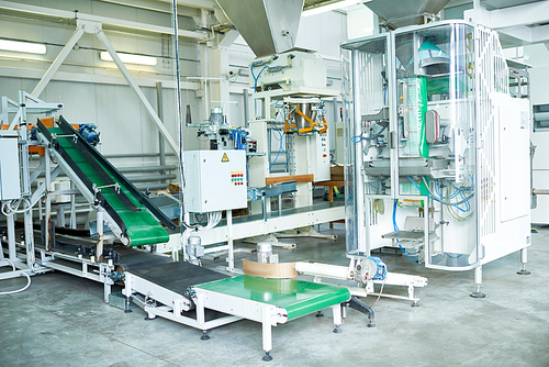 Interior of production workshop at food factory, group of modern assembly line units , copy space