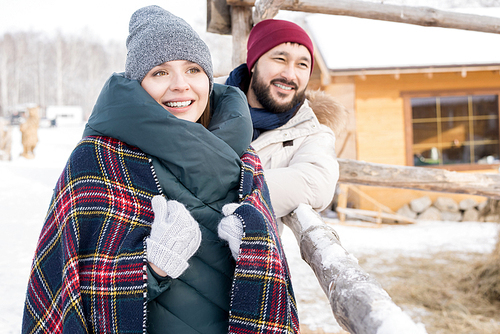 Portrait of modern young couple enjoying winter vacation together walking in nature at ski resort, copy space