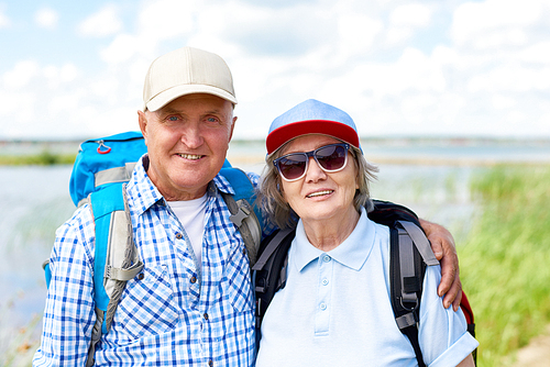Portrait of active senior couple travelling on hiking trip, smiling  enjoying vacation