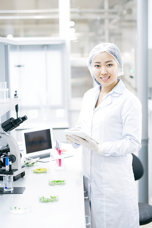 Portrait of Asian female scientist  smiling happily while doing research in medical laboratory