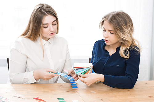Two female designers working with color sketches