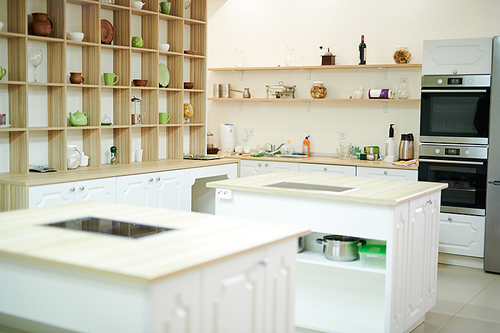 Background shot of interior in modern restaurant kitchen with stoves and equipment, copy space