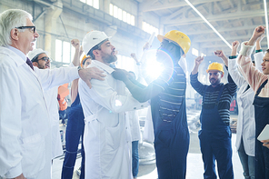 Side view  portrait of angry African-American worker fighting with managers during protest in industrial workshop, lens flare