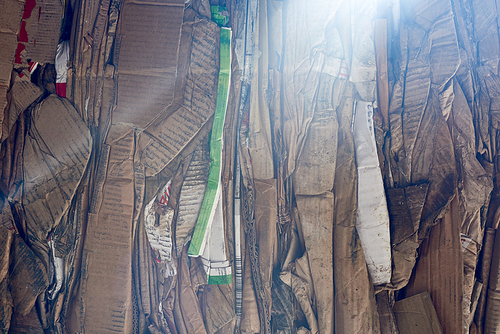 Close up background of packed cardboard block at modern recycling factory, copy space