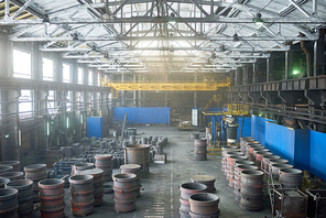 Interior of spacious production department of modern plant illuminated with sunbeams coming from panoramic windows, no people