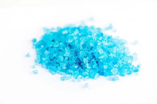 Close up shot of blue crystals isolated on white, chemical industry concept