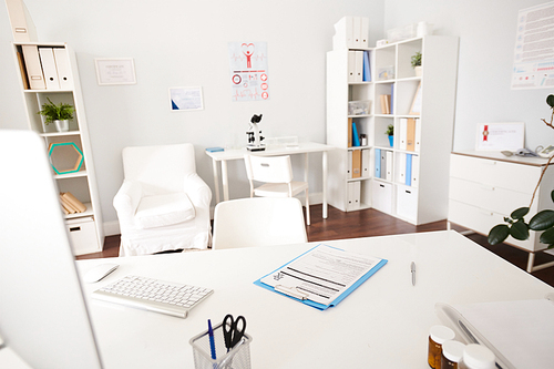 Background image of empty white doctors office interior with desk in foreground  in modern private clinic, copy space