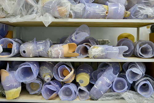 Background image of prosthetic leg parts on shelves in modern medical  engineering laboratory