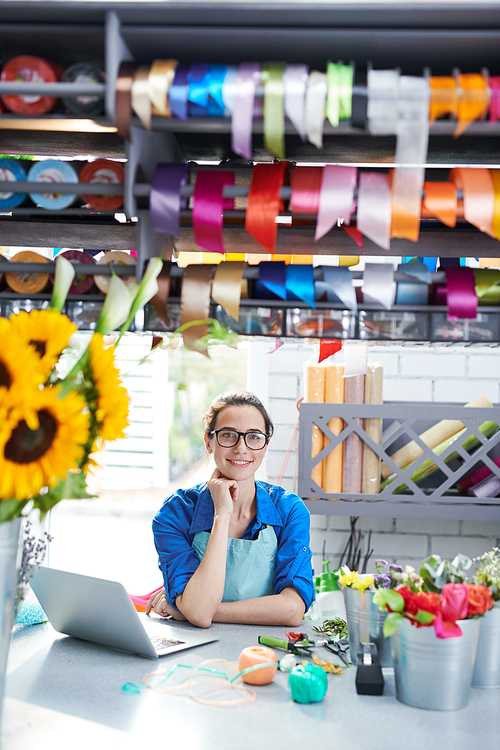 Portrait of young female businesswoman  and smiling while managing flower shop, copy space
