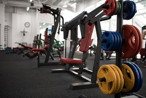 Background image of exercise machines for weight training in empty modern gym, copy space
