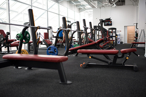 Background image row of weight training benches in empty modern gym, copy space
