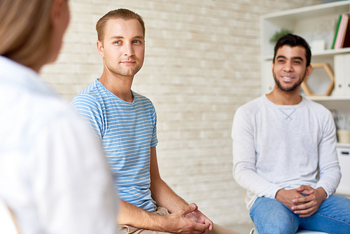 Support group having psychological therapy at cozy office: they sitting in circle and sharing their problems with other participants