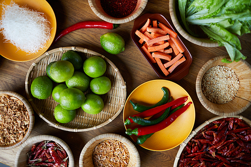 Top view background of various spices in wooden bowls on table, copy space