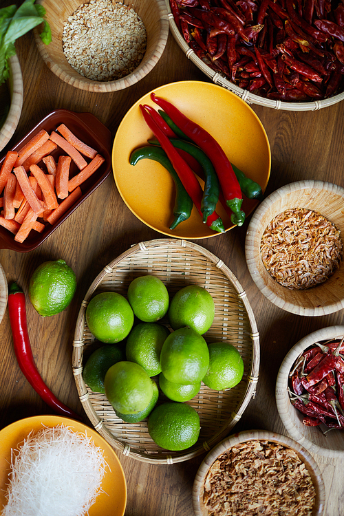 Top view background of various spices and ingredients in wooden bowls on table, copy space