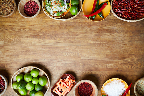 Food background of various spices standing on wooden table, copy space