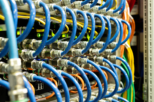 Background image of modern network cables connected in switches in database server room, copy space