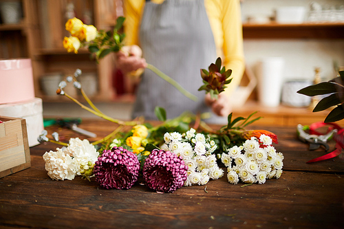 Closeup of assorted flowers lying on counter in flower shop, copy space