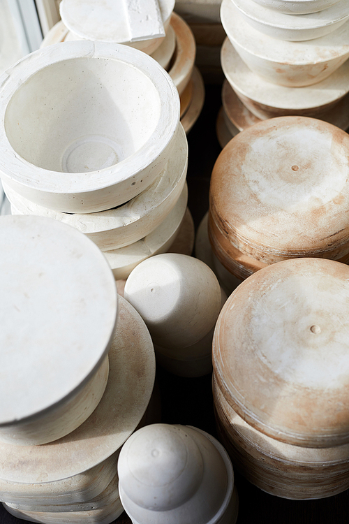 Above view background image of handmade ceramic bowls on shelf in pottery workshop, copy space