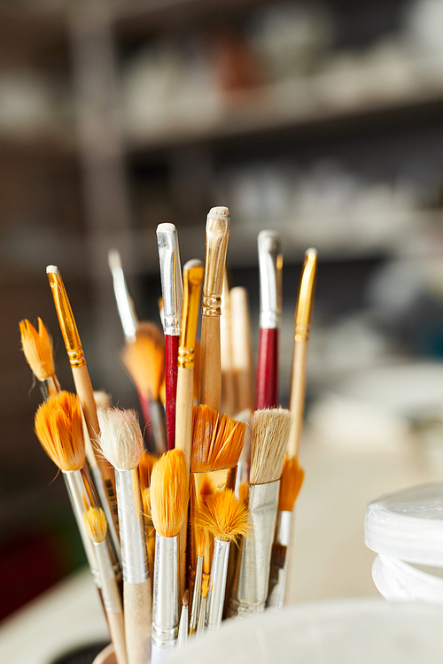 Close up of paintbrushes on table in art studio, copy space