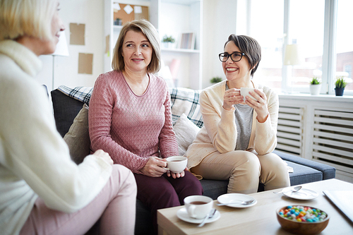 Portrait of two smiling women drinking tea enjoying break at work, copy space