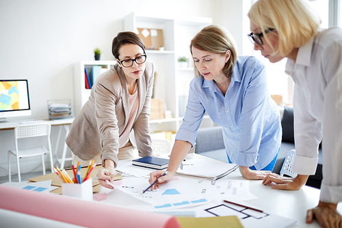 Group of successful businesswomen working together on design project in studio, copy space