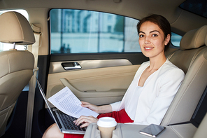 Portrait of smiling businesswoman  while working in car , copy space