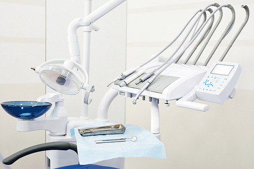 Background image of dental instruments and equipment in empty dentists office, copy space