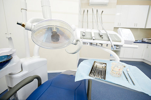 Background shot of dental chair and equipment in empty dentists office, copy space