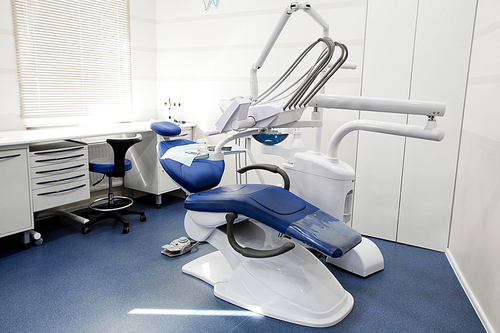 Wide angle background shot of dental chair and equipment in empty dentists office, copy space