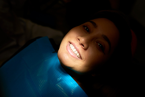 Happy patient of dentistry with glowing white smile after treatment