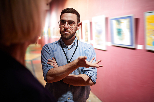 Portrait of art gallery workers discussing art in museum exhibition, copy space