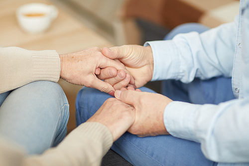 Close up of senior couple holding hands supporting each other, copy space