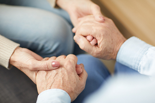 Closeup of senior couple holding hands supporting each other, copy space