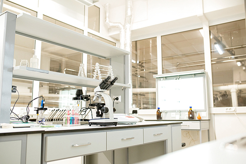 Laboratory place with glassware, modern devices and optical instruments used for scientific research