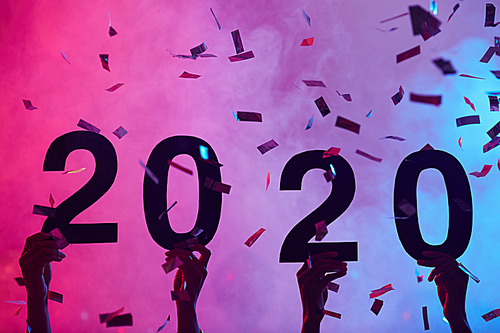Background image of hands holding 2020 during Christmas party in nightclub with glittering confetti, copy space